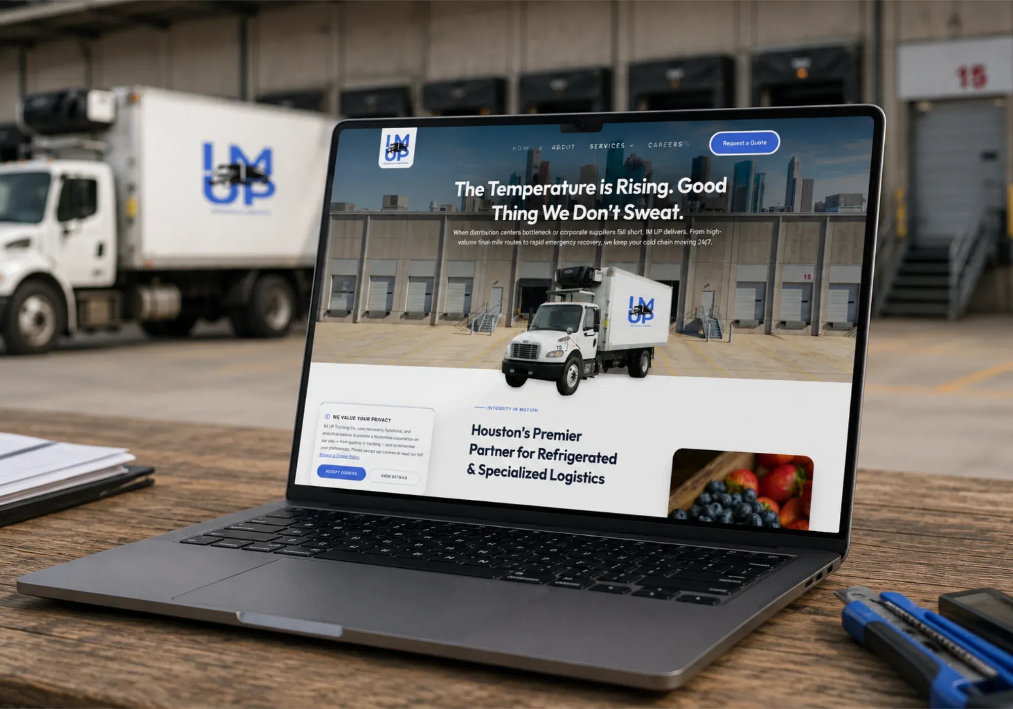 The IM UP Trucking website on a laptop, highlighting refrigerated and specialized logistics